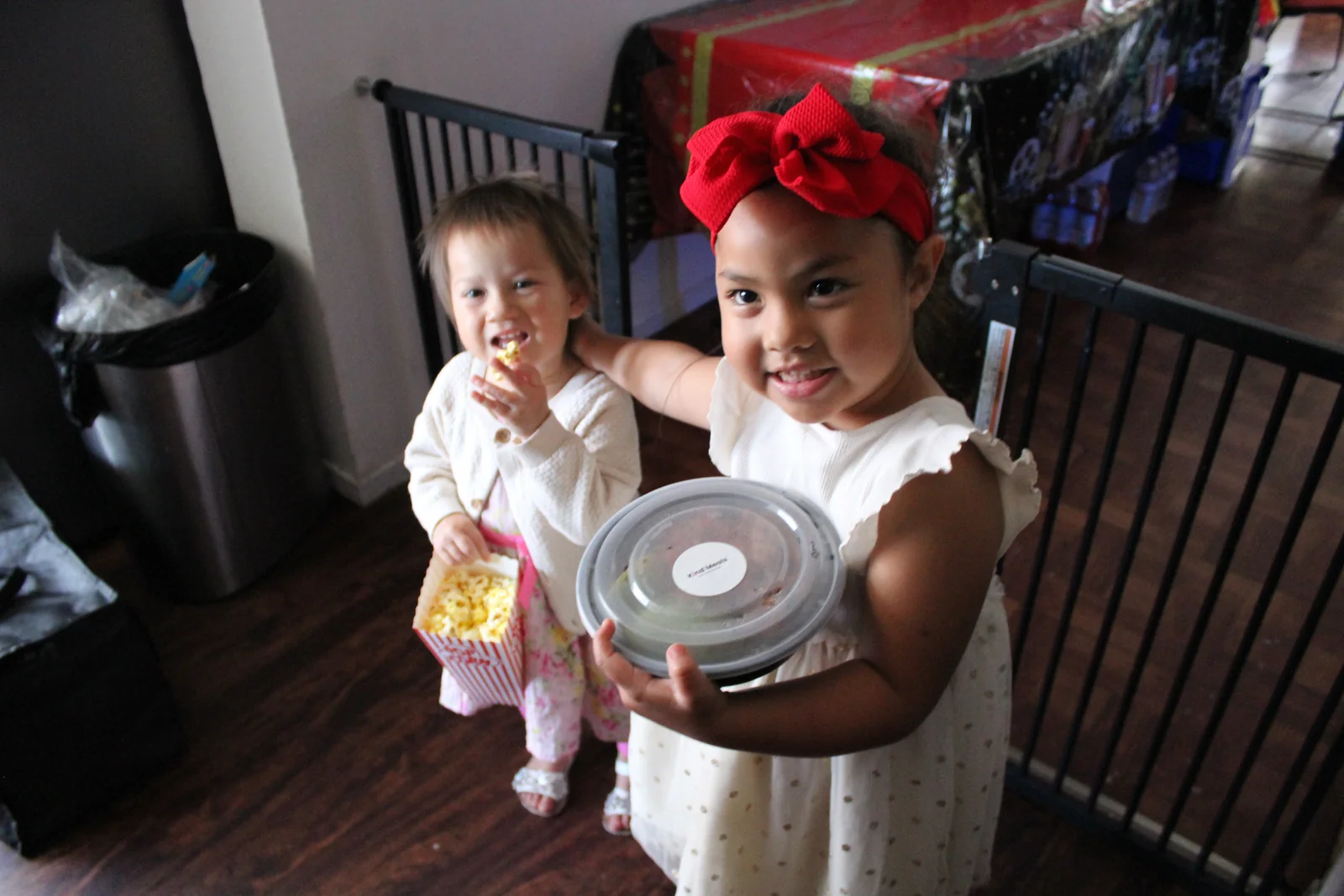 A child holding a labeled Kind Meals container at a Dreams of Kindness meal distribution in Southern California